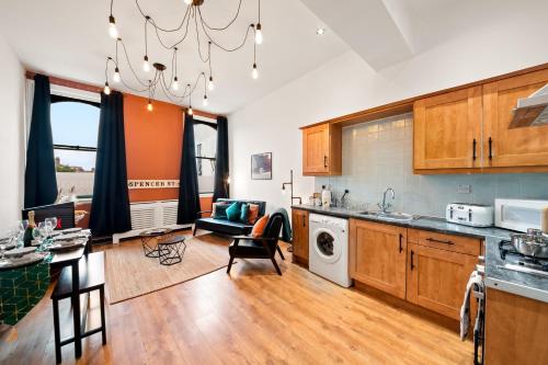 a kitchen with a living room and a dining room at Spacious Birmingham City Apartment in Birmingham