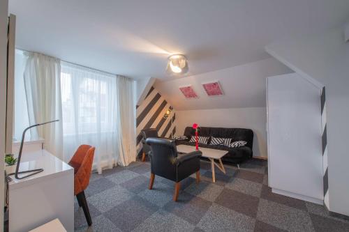 a living room with a couch and a table at Apartmani Maximilian in Čukarica
