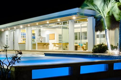 a house with a swimming pool at night at Modern & fresh | Villa Arroyito w/Pool & Barbecue in Cartagena de Indias