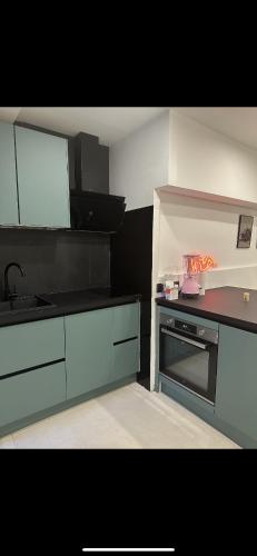 une cuisine avec un évier et une cuisinière dans l'établissement Love room, à Chennevières-sur-Marne