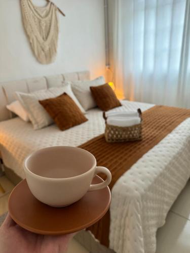 a bowl on a table in front of a bed at Granbalaio Hostel in Blumenau