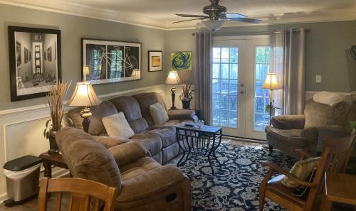 a living room with a couch and a chair at Classic City 3 bedroom 2 bath condo with deck close to UGA, Five Points, and Memorial Park in Athens in Athens