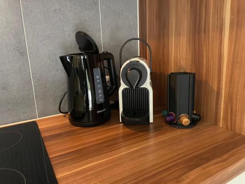 a counter with various appliances sitting on a wooden table at Apart Alpenview in Umhausen