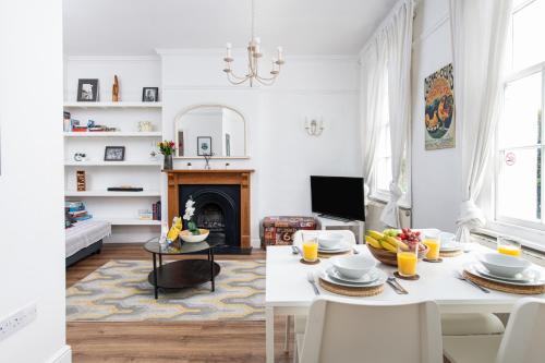 a living room with a table and a fireplace at Central Flat-2Bed-Free Parking-By FabAccommodation in Bristol