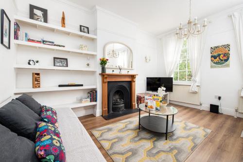 a living room with a couch and a fireplace at Central Flat-2Bed-Free Parking-By FabAccommodation in Bristol