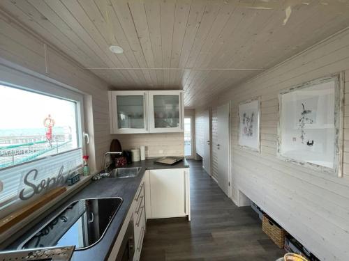 a kitchen with a sink and a counter top at Hausboot Sophie in Stralsund in Stralsund