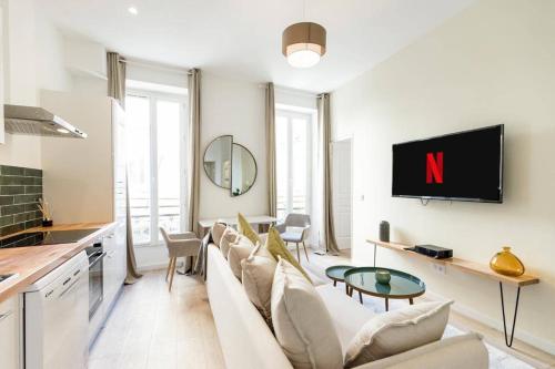 un salon avec un canapé blanc et une télévision dans l'établissement T2 Cocoon in the heart of Cours Julien | By Airnest, à Marseille