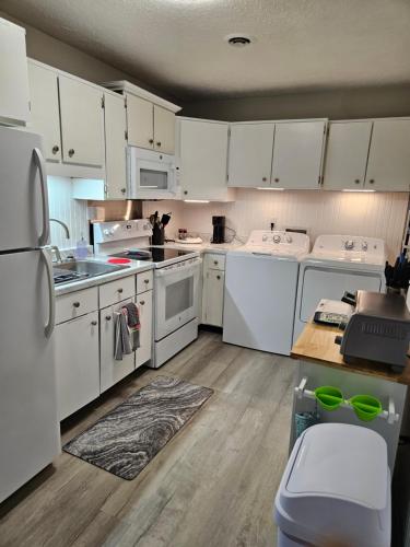 a kitchen with white appliances and white cabinets at Mountain View Retreat 5 min to LMU in Harrogate