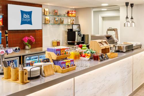 a restaurant counter with food items on it at ibis budget Leicester in Leicester