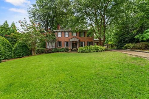 a large yard in front of a brick house at 5BR Atlanta Historic-Sleeps 10-Near Emory & CDC in Atlanta