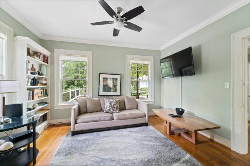 a living room with a couch and a ceiling fan at 5BR Atlanta Historic-Sleeps 10-Near Emory & CDC in Atlanta