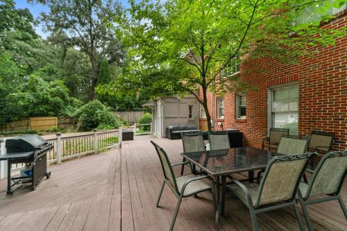 a patio with a table and chairs and a grill at 5BR Atlanta Historic-Sleeps 10-Near Emory & CDC in Atlanta