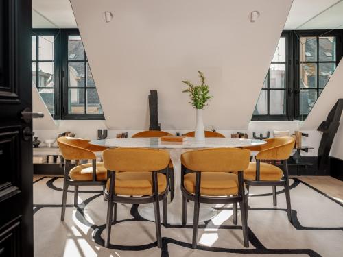 a dining room with a table and chairs at Balthazar Hotel & Spa Rennes - MGallery Collection in Rennes
