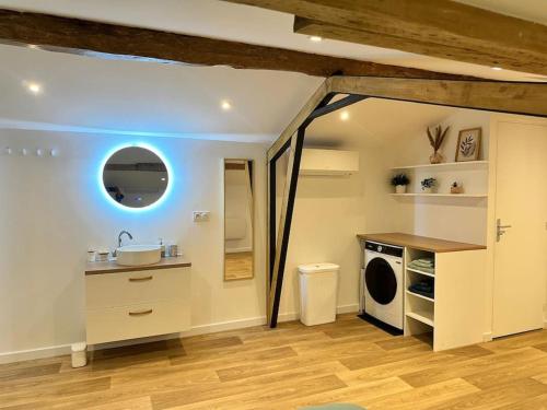 une salle de bain avec un lavabo et une machine à laver dans l'établissement Joli appartement - Roques, à Roques