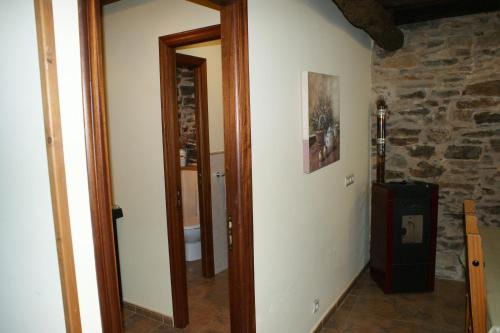 a hallway with a room with a stone wall at O Bolaño Apt 2 in Parada de la Sierra