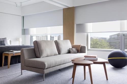 a living room with a couch and a table at Hotel Stage in Hong Kong