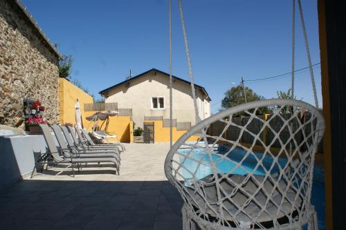 a group of chairs sitting next to a swimming pool at O Bolaño Apt 1 in Parada de la Sierra