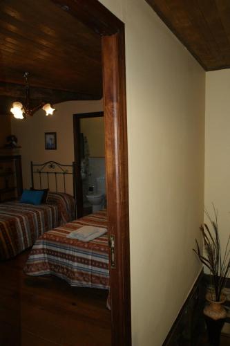 a bedroom with two beds and a mirror at O Bolaño Apt 1 in Parada de la Sierra
