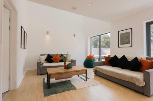 a living room with two couches and a coffee table at Central Cambourne Place Retreat in Gateshead