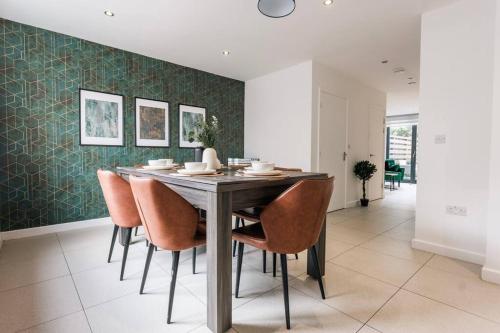 a dining room with a table and chairs at Central Cambourne Place Retreat in Gateshead