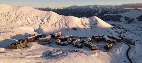 a resort on top of a snow covered mountain at Atrium New Gudauri by Gudauri Travel in Gudauri