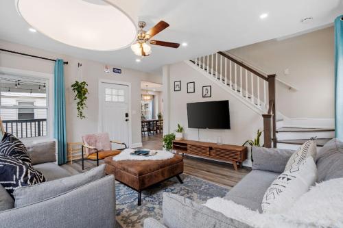 a living room with a couch and a tv at Beautifully Renovated 6BR 2BA 2 Blocks to Beach in Atlantic City