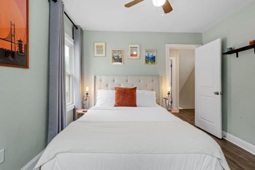 a bedroom with a large white bed and a window at Beautifully Renovated 6BR 2BA 2 Blocks to Beach in Atlantic City