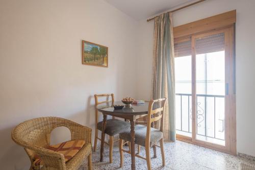 a dining room with a table and chairs and a window at Casa El Rincón de Trini & Jose in Quéntar