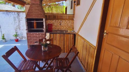 a small kitchen with a table and chairs on a balcony at Vila dos Bangalôs in Barreirinhas