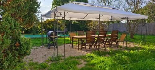 a table and chairs under an umbrella in a yard at Apartament nad morzem z podwórkiem in Będzino