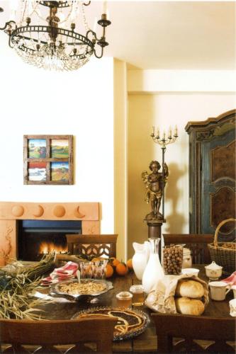 a dining room with a table and a fireplace at L'Atelier di Pierflavio Gallina in La Morra