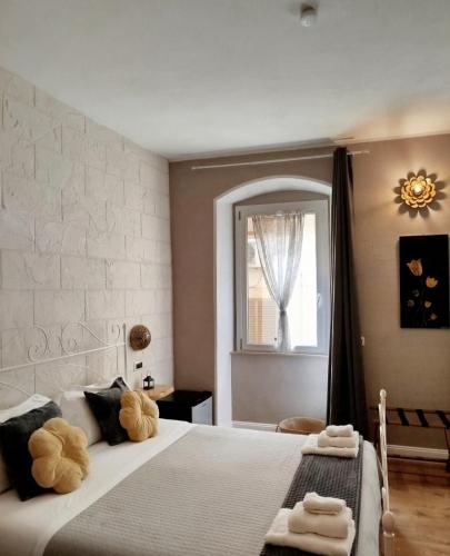 a bedroom with a bed with two teddy bears on it at L'Accademia dei Sogni in Sassari