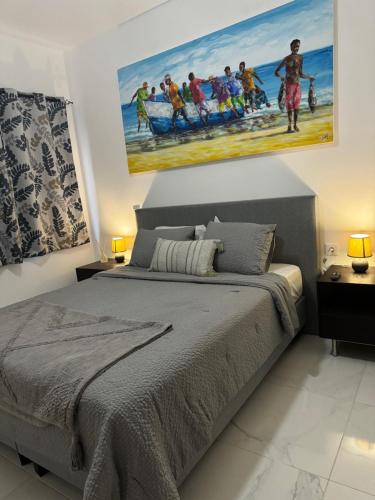 a bedroom with a bed and a painting on the wall at NEW Luxury Condo - In the heart of Santa Maria in Santa Maria