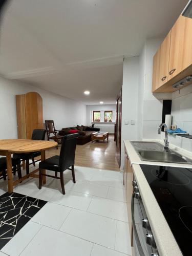 a kitchen and living room with a table and a dining room at Apache Königswinter in Königswinter