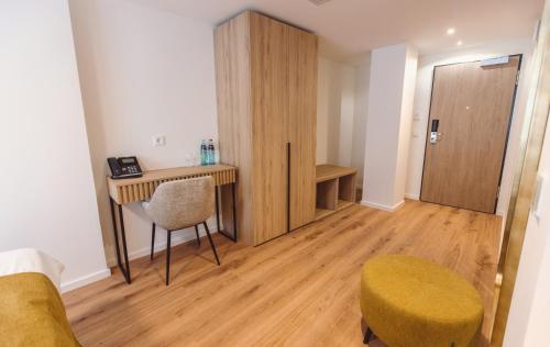 a room with a desk and a chair and a table at Hotel am Rathaus in Freiburg im Breisgau