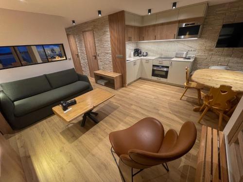 un salon avec un canapé et une table dans l'établissement Tignes Lac - Appartement rénové - 50 m des pistes, à Tignes