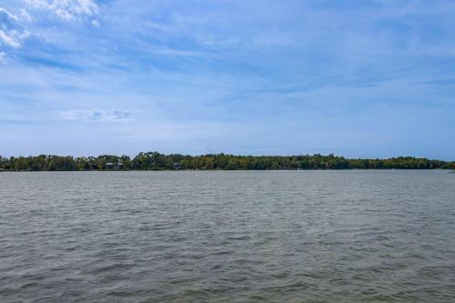 a large body of water with trees in the background at Pequot Lakes Retreat with Beach and Fire Pit! in Pequot Lakes
