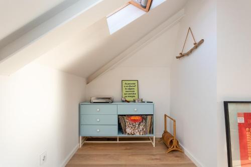 a room with a blue dresser in a attic at La Concha Alegre, Duplex in Trafaria in Trafaria