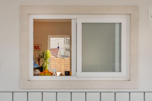 a window with a view of a room at La Concha Alegre, Duplex in Trafaria in Trafaria