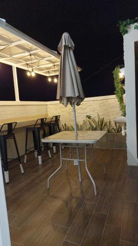 an umbrella sitting on a table on a patio at De AR Guest House Gresik in Giri