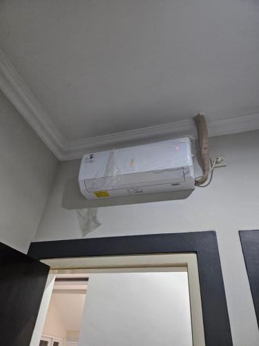 a air conditioner is on the ceiling of a room at De AR Guest House Gresik in Giri