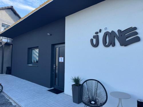 a white building with a sign on the side of it at j ONE Apartmány in Pardubice