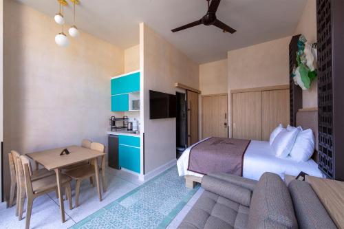 a hotel room with a bed and a table at Casa Filomeno in Mexico City
