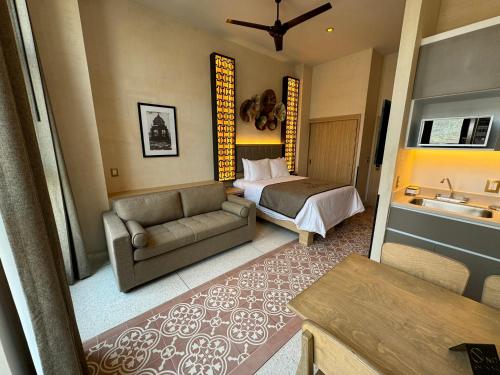 a living room with a bed and a couch in a room at Casa Filomeno in Mexico City