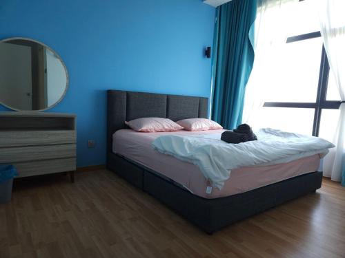 a bedroom with a bed with a teddy bear on it at House Of 99 in Kuantan