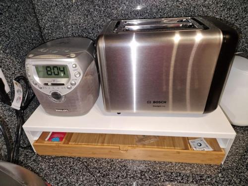 a toaster sitting on a shelf next to a scale at House in Camara de Lobos in Estreito de Câmara de Lobos