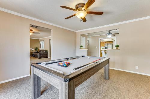 a pool table in a living room with a ceiling fan at Pet-Friendly Home with Game Room in Las Vegas! in Las Vegas