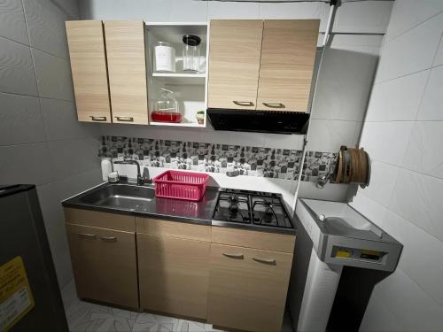 a small kitchen with a sink and a stove at Aparta Suite Torre De Prado 403 in Medellín