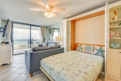 een woonkamer met een bed en een bank bij Oceanfront Condo with Heated Pool in Emerald Surf! in Navarre