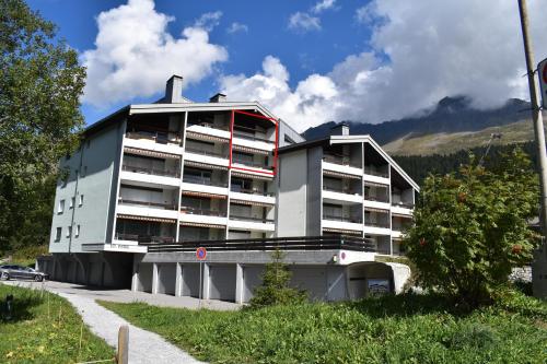 a white apartment building in front of a mountain at Haus im Park 11 in Valbella